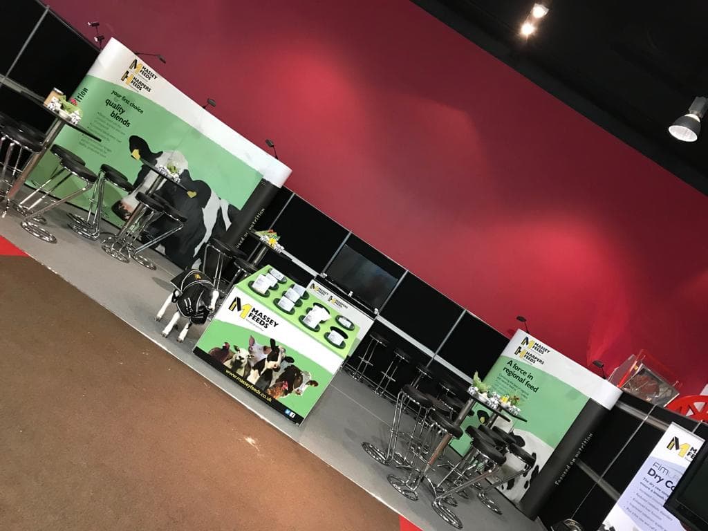 Massey Feeds stand with bar stools and AV display